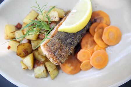 Baked salmon with lemon and carrotの写真素材