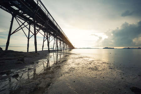beach with bridge in long exposure