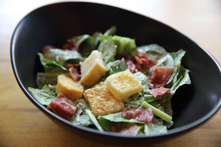 caesar salad on wood backgroundの写真素材