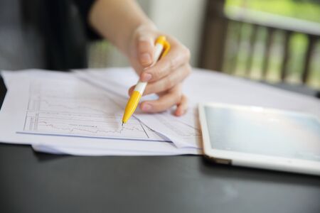 Office Woman hand Working on the Business Papers and tablet