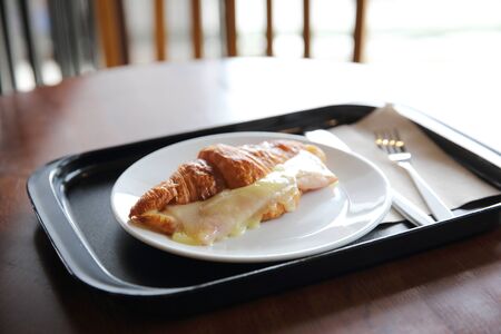 Croissant Ham cheese on woodの写真素材