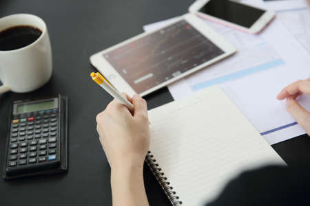 Office Woman hand Working on the Business Papers and tabletの写真素材