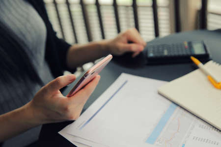 Asian woman with smart phone with businessの写真素材