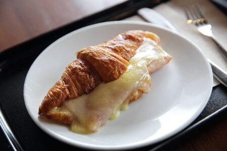 Croissant Ham cheese on woodの写真素材