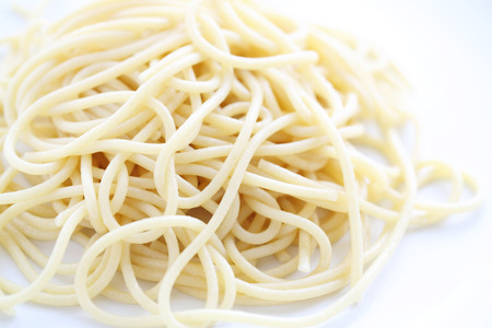 Spaghetti noodle isolated in white backgroundの写真素材
