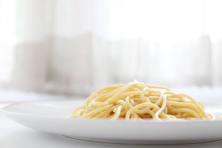 Spaghetti noodle isolated in white backgroundの写真素材
