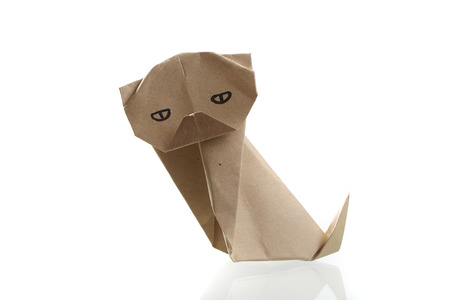 Origami dog papercraft by recycle paper isolated in white backgroundの写真素材