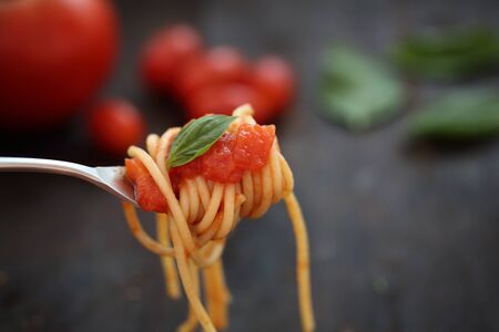 spaghetti with tomato sauce and Basil in dark wooden backgroundの写真素材