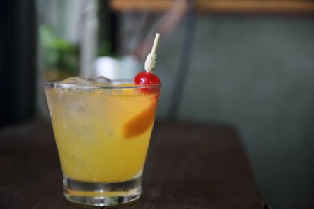 mai tai cocktail with orange cherry fruits on wood background