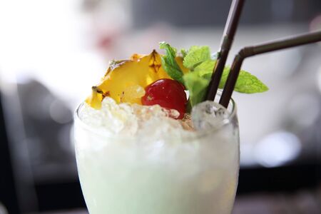 pina colada cocktail with pineapple and cherry fruitの写真素材