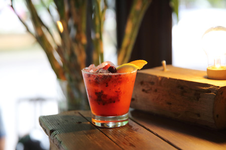mai tai cocktail with orange cherry fruits on wood backgroundの写真素材