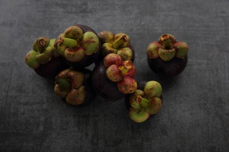 Mangosteen fruit on dark rock backgroundの写真素材
