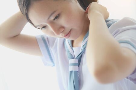 School girl getting dressed on white roomの写真素材