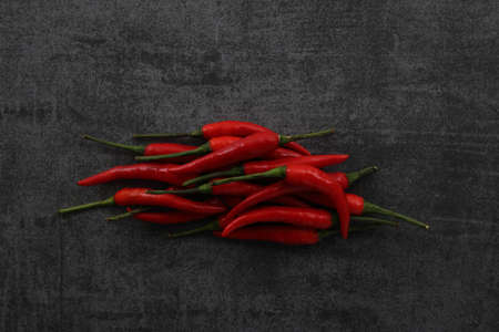 Chili pepper on dark rock background