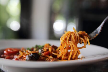Spaghetti witn tomato and olive , Italian foodの写真素材