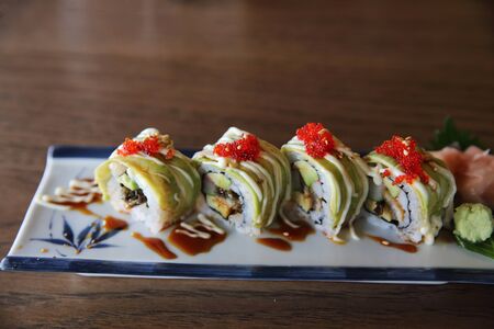 Avocado sushi maki on wood background , Japanese foodの写真素材