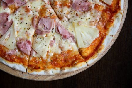 pizza hawaiian , pizza with pineapple and ham with cheese and tomatoes sauce on wood background , italian foodの写真素材