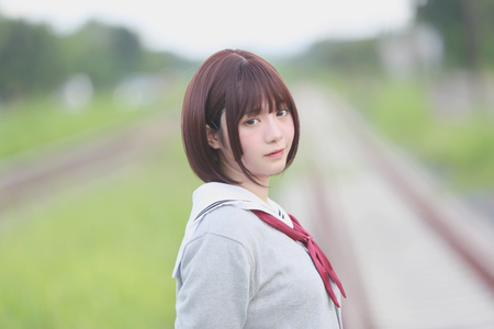 Portrait of Japanese school girl with countryside parkの写真素材
