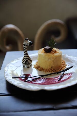 Cheese cake with blueberry jam sauce sweet food on wood backgroundの写真素材