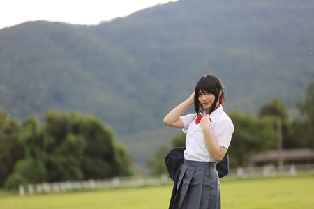 Japanese school in countryside with grass mountain and tree の写真素材
