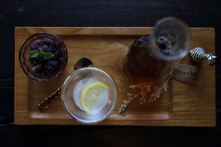 Berries tea with ice ball on wood backgroundの写真素材