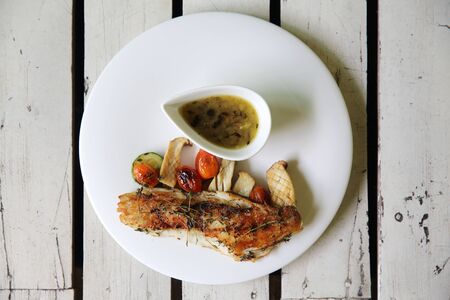 Sea bass fillet on wood background の写真素材