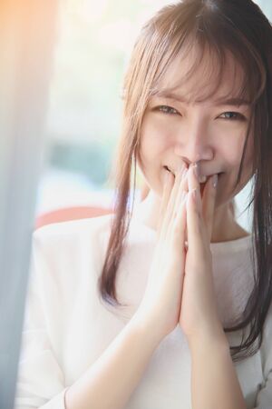 Asian young woman portrait in bed room with white toneの写真素材