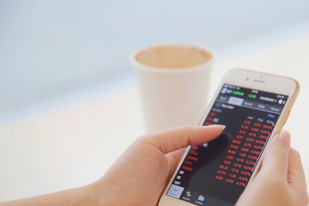 business trading online on smartphone with woman hand