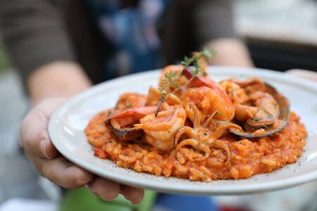 seafood risotto with mussel shrimp and squid , italian food with handの写真素材