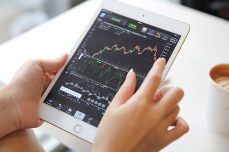 Woman hand business Trading online on tablet and coffeeの写真素材