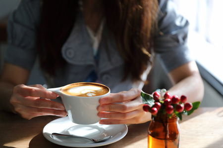 Cappuccino coffee break on wood backgroundの写真素材