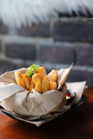 French fries in vintage style on wood backgroundの写真素材