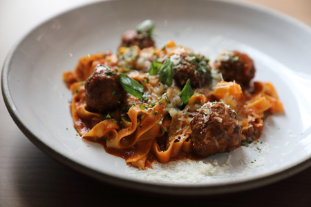 Spaghetti pasta with beef meatballs and tomato sauce on wood background . italian foodの写真素材