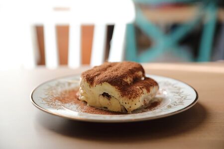 Tiramisu cake on wood backgroundの写真素材