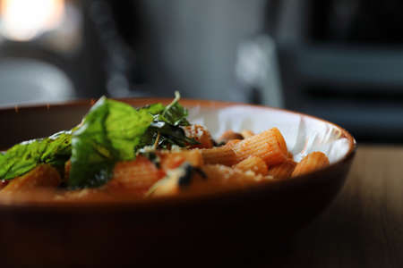 Pasta with sausage in tomato sauce on wood background , italian foodの写真素材