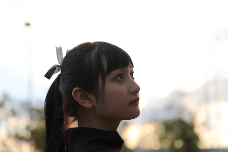 Young pretty girl wearing black cotton sweatshirt outdoor backgoundの写真素材
