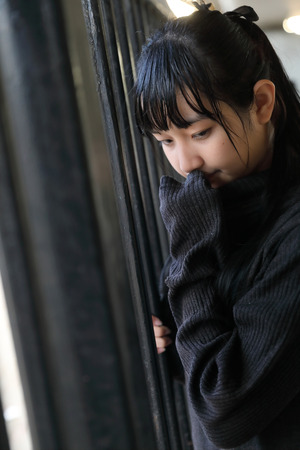 Young pretty girl wearing black cotton sweatshirt outdoor backgoundの写真素材