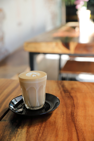 cappuccino or Latte art coffee made from milk on the wood table in coffee shopの写真素材