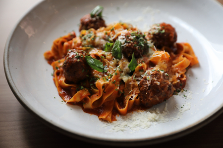 Spaghetti pasta with beef meatballs and tomato sauce on wood background . italian foodの写真素材