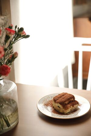 Tiramisu cake on wood backgroundの写真素材