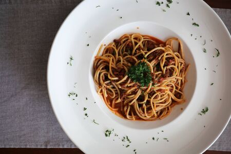Spaghetti bolognese with beef tometo sauce on wood table , italian foodの写真素材