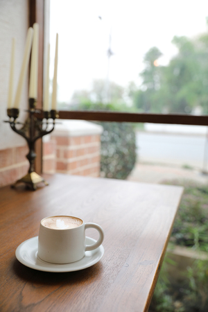 cappuccino or Latte art coffee made from milk on the wood table in coffee shopの写真素材
