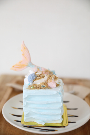 Fancy mermaid cake on wood backgroundの写真素材