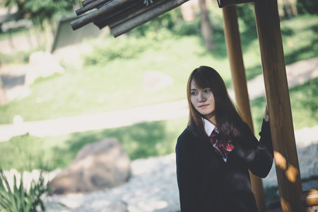 Portrait japanese school girl in japanese garden and bamboo forestの写真素材