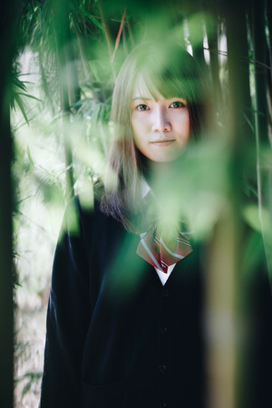 Portrait japanese school girl in japanese garden and bamboo forestの写真素材