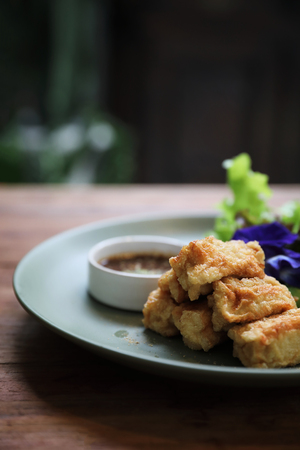 Vegan food japanese fried tofu on wood background vintage styleの写真素材