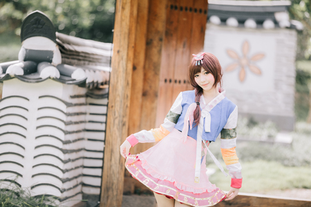 Portrait of Hanbok costume young woman looking and smile in korean parkの写真素材