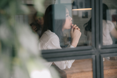 Portrait of young woman looking in coffee shop modern life style