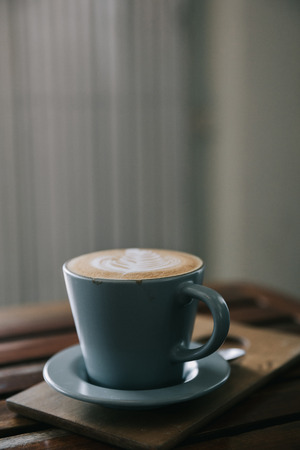 cappuccino or Latte art coffee made from milk on the wood table in coffee shop vintage film styleの写真素材