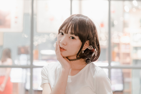 Portrait young woman thinking and looking modern style in night outdoor urban backgroundの写真素材